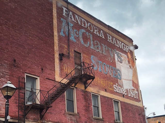 side of an old brick building with a fire escape 
